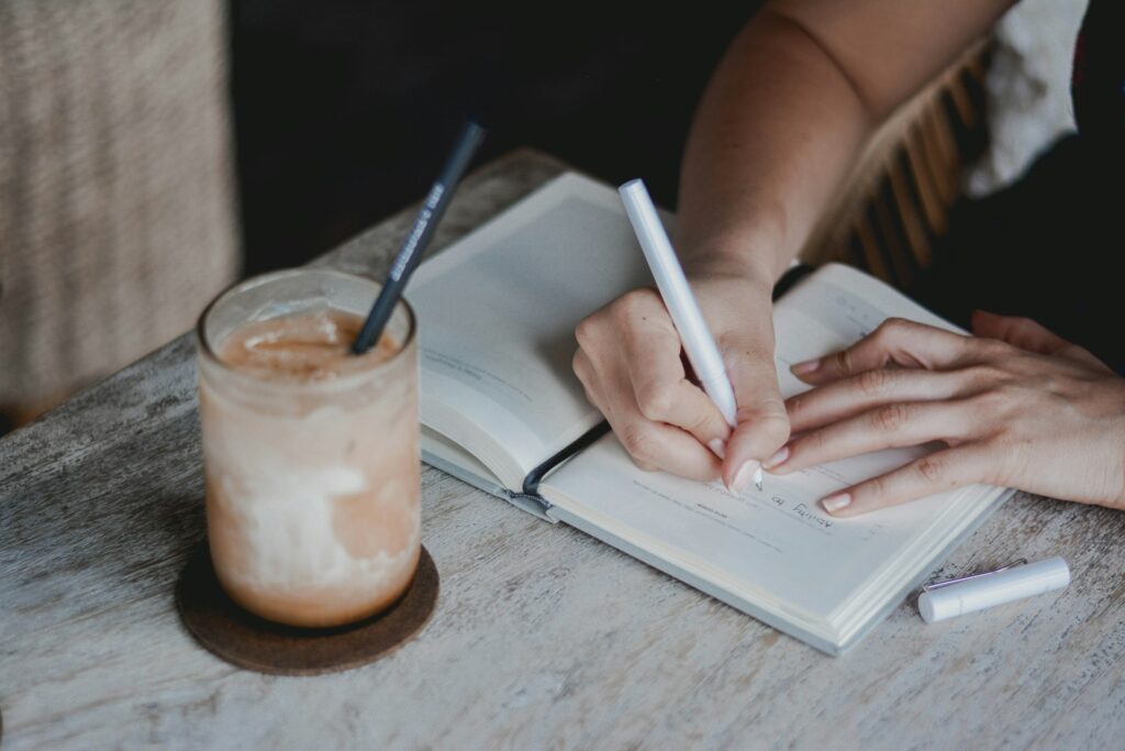 Person writing on white paper