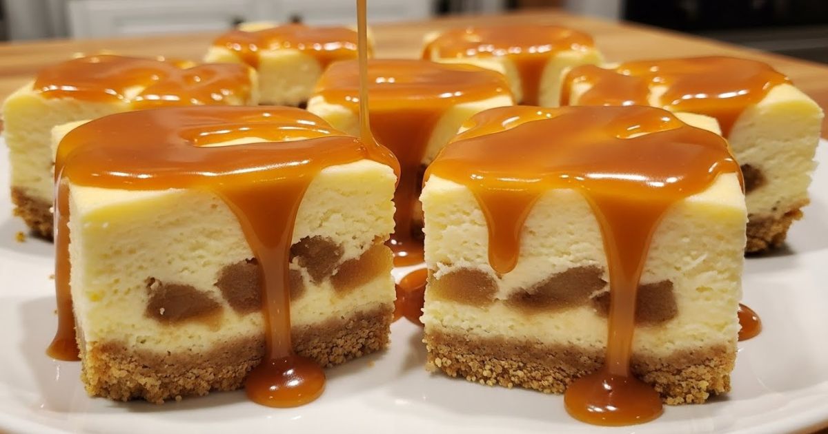 Caramel apple cheesecake bars sliced into squares on a plate, caramel drizzle on top