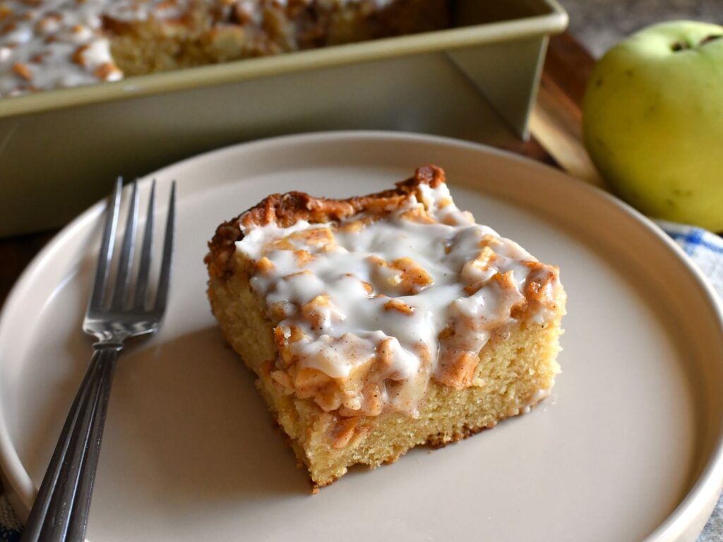 A single square of Apple Fritter Cake on a white plate